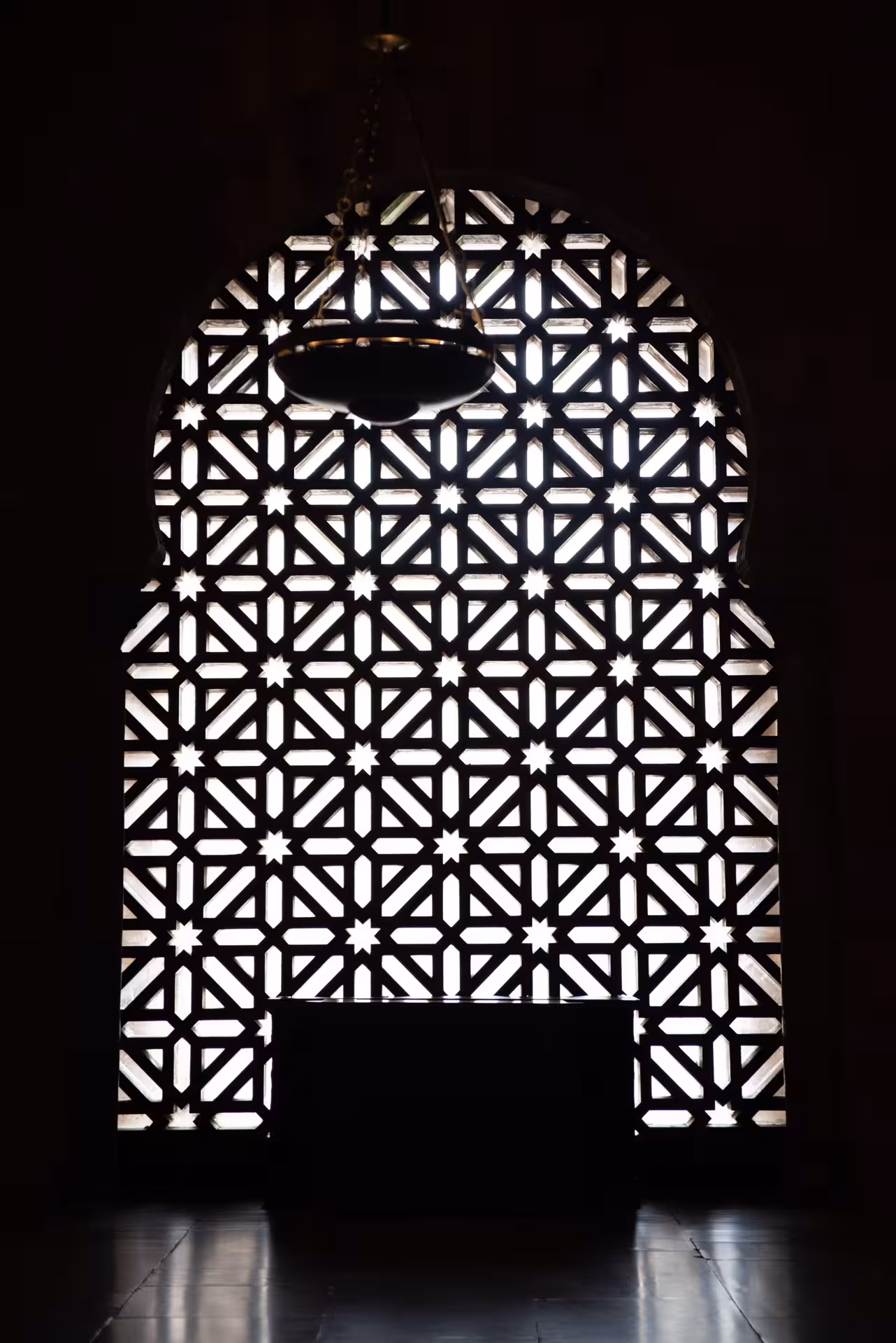 Intricate lattice window design in the Mosque-Cathedral of Córdoba, showcasing Moorish architectural elegance.