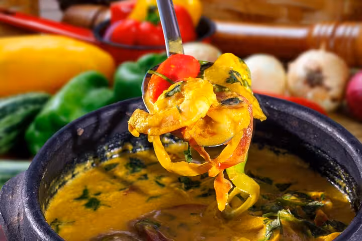 A vibrant moqueca dish with prawns and vegetables, showcasing traditional Bahian flavors in Salvador's cooking class.