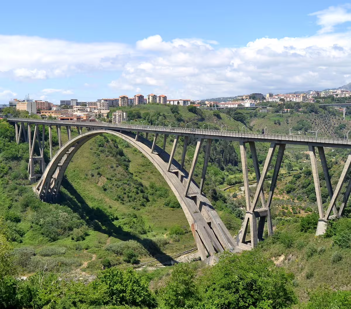 Panoramic view of the Morandi Bridge in Cosenza arching over a lush green valley on a Calabria mythological tour
