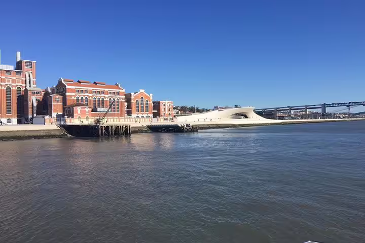 View of the MAAT and historic buildings along the Tagus River on a clear day during a Lisbon morning sailing tour.