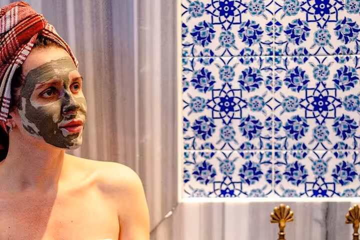 Woman enjoying Moroccan clay face mask in Royal Hammam spa experience in Sharm El Sheikh, Egypt