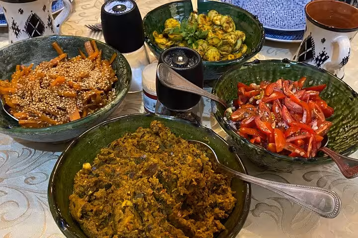 A vibrant spread of Moroccan dishes including salads and spiced vegetables prepared in the cooking class.