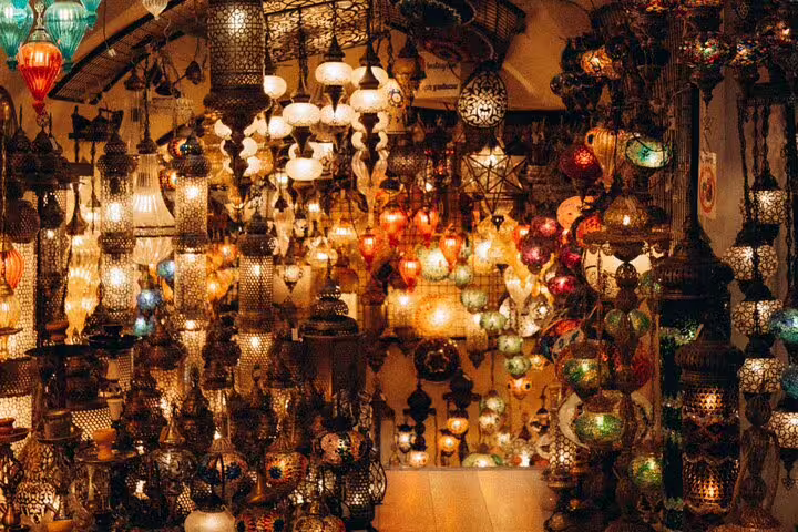 Colorful Moroccan-style mosaic lanterns glowing in a Khan el-Khalili shop on a Medieval Cairo bazaar tour
