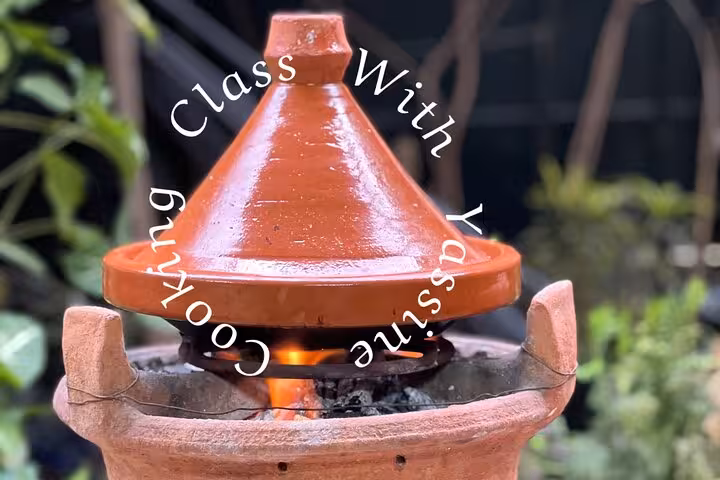 Traditional Moroccan tagine cooking over an open flame at Cooking Class with Yassine & Mom.