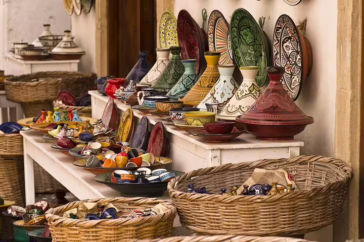 Traditional Moroccan tagines, plates and ceramics at a Marrakech medina market during a half-day guided tour