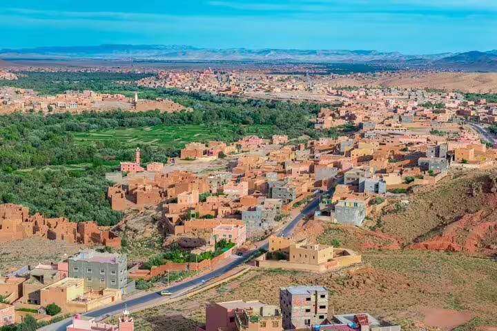 Panoramic view of a Morocco kasbah village and palm oasis on the 3 days desert tour from Fes to Marrakech