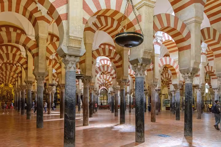 Explore the stunning arches of the historic Mosque-Cathedral of Córdoba on our guided Andalusia tour from Lisbon.