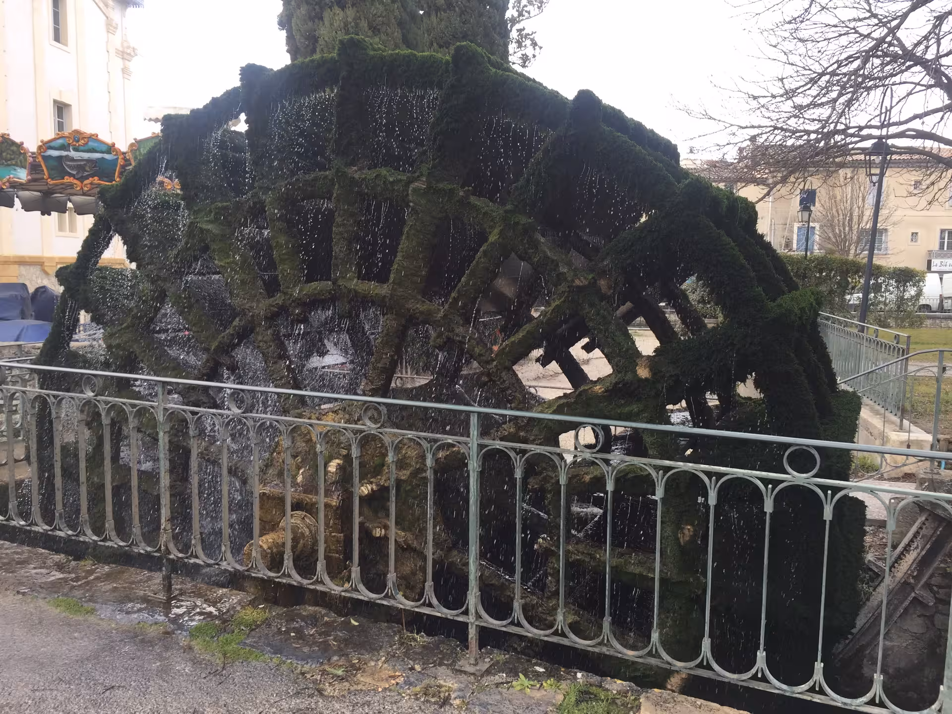 Moss-covered water wheel in L'Isle-sur-la-Sorgue, iconic Provence highlight on the Gordes and Roussillon tour