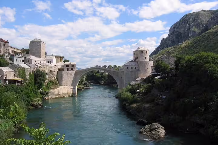 Panoramic view of Mostar Old Bridge and Neretva River canyon on a Makarska Riviera sightseeing tour