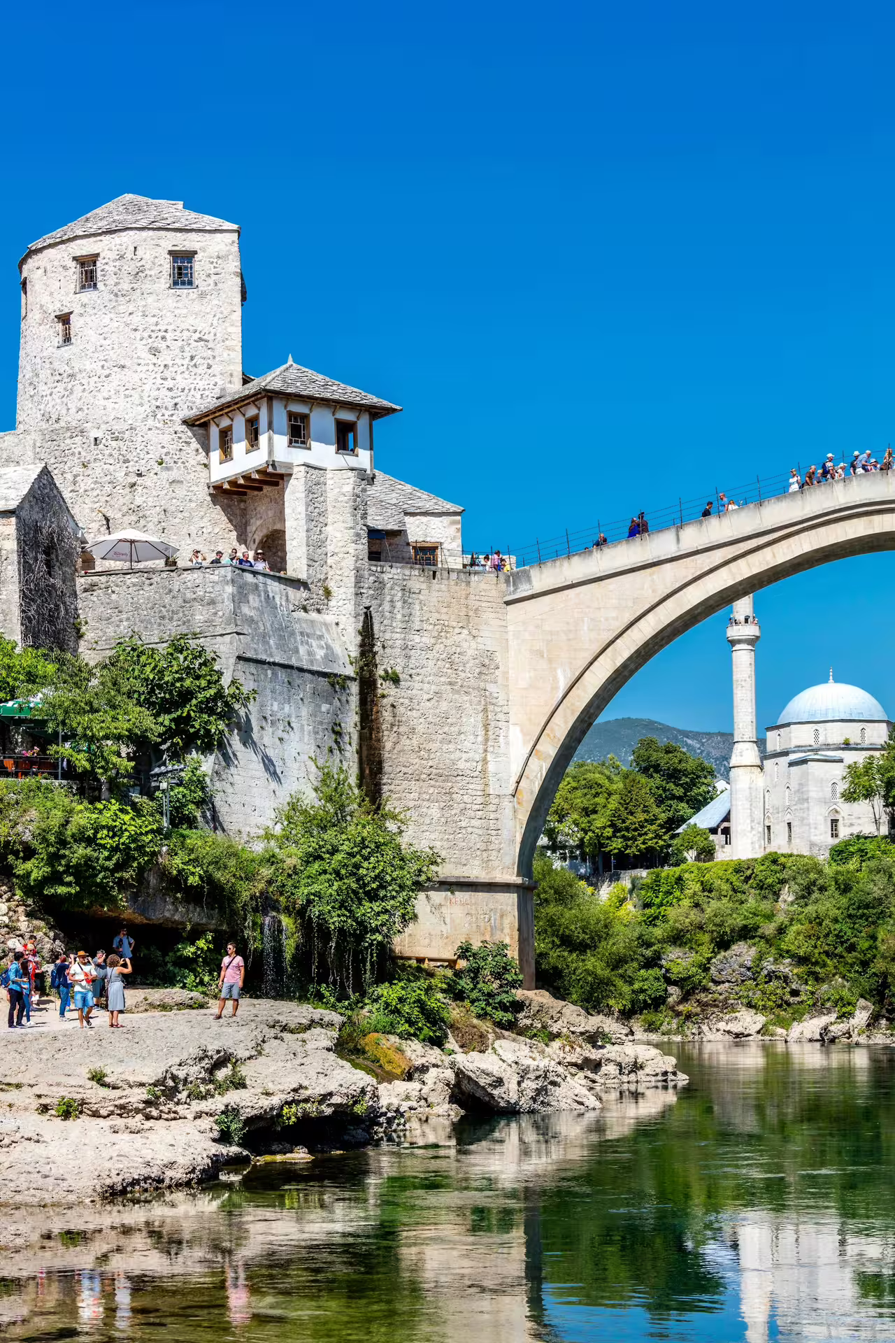 Mostar Old Bridge and Ottoman tower over Neretva River, highlight stop on Dubrovnik day trip city tour