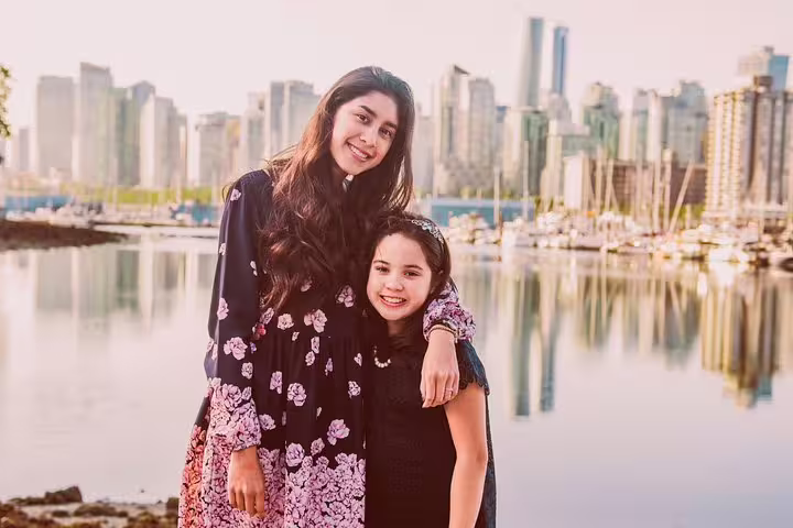 Mother and daughter portrait at Coal Harbour marina with Vancouver skyline, personal travel photographer tour