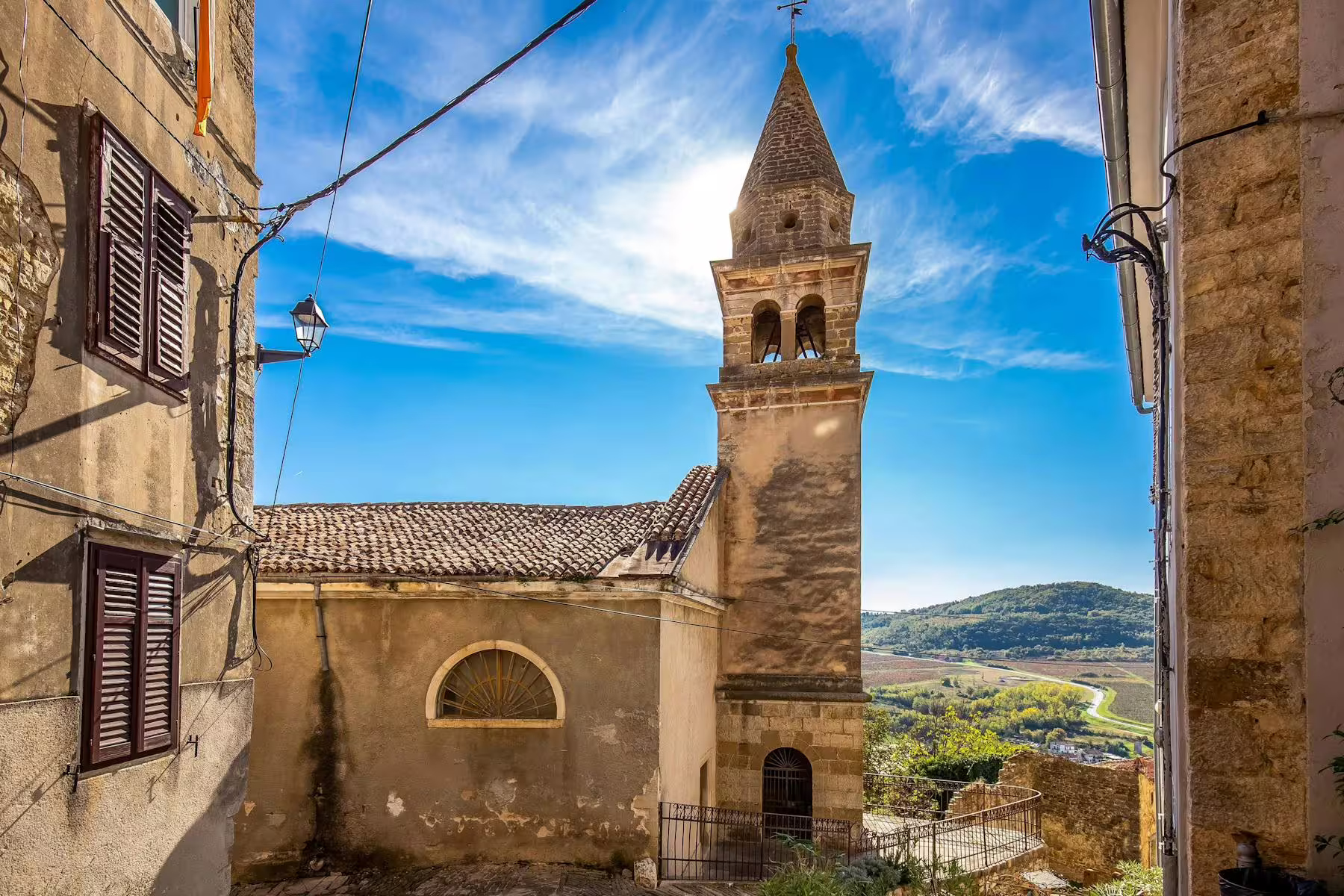 Motovun old town church bell tower above Istrian hills on half-day tour with truffle and local brandy tasting