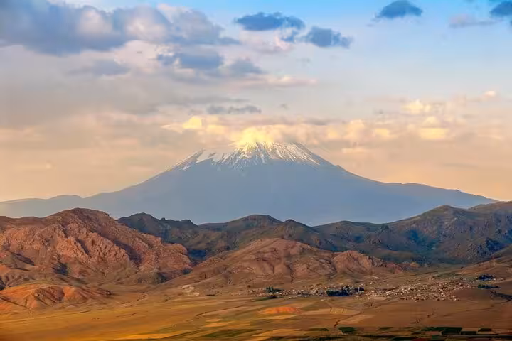 Snow-capped Mount Ararat at sunset over rugged hills, scenic view on all-inclusive 7-day private trek