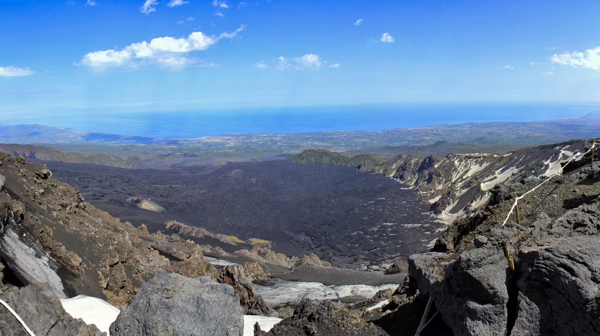 Panoramic Mount Etna summit view over lava fields to the Ionian Sea on Taormina shore excursion