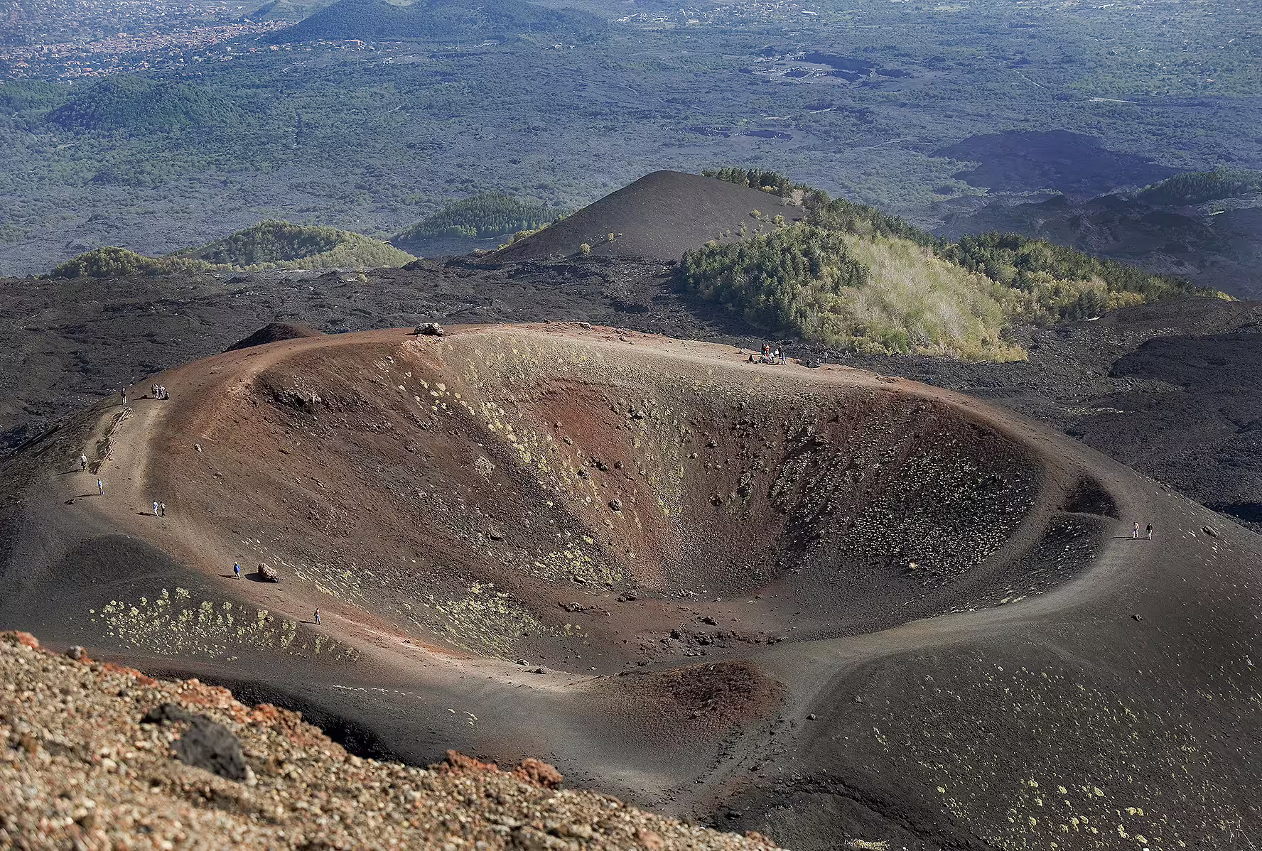 Hiking around a Mount Etna volcanic crater on Taormina port tour, exploring lava fields and panoramic views