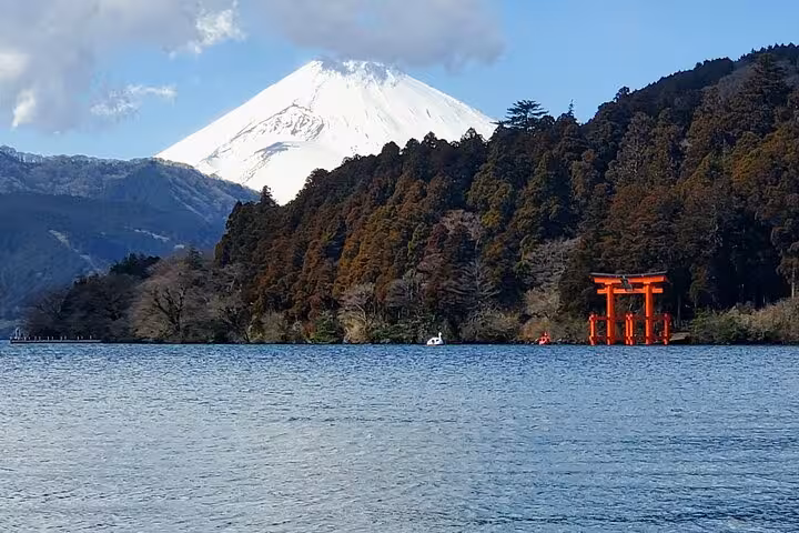 Majestic Mount Fuji and red torii gate overlooking Lake Ashi's serene waters on a customizable Hakone tour.