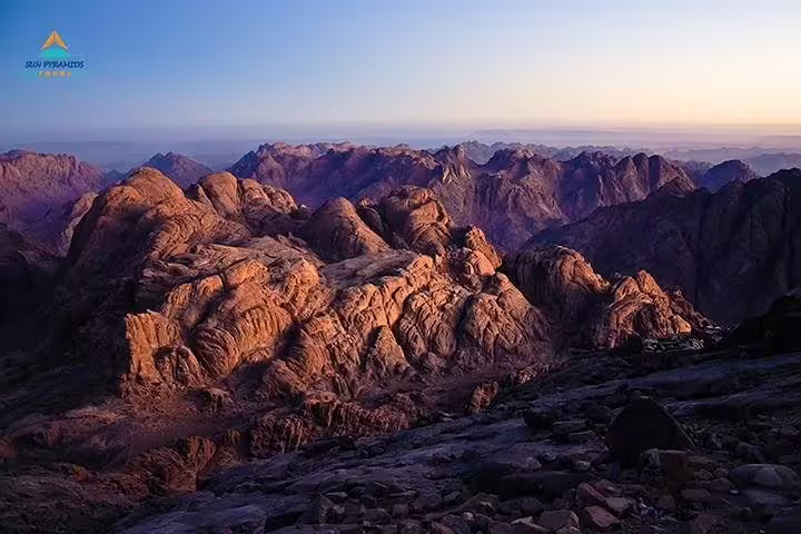 Golden dawn light on Sinai mountains viewed from Mount Moses, private overnight tour from Dahab with guide
