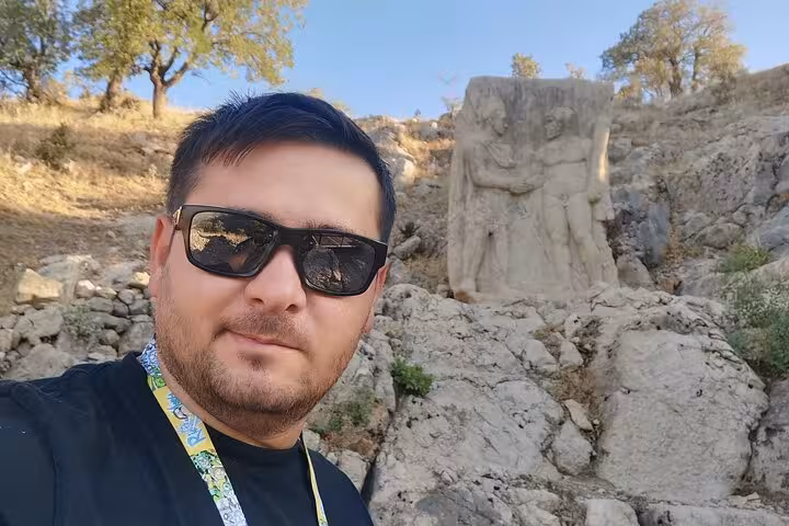 Traveler at Mount Nemrut stone reliefs, Mesopotamia stop on 9-day private Cappadocia tour Turkey