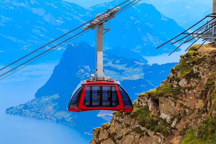 Aerial cable car ascending Mount Pilatus with panoramic views of Lake Lucerne on a private tour.