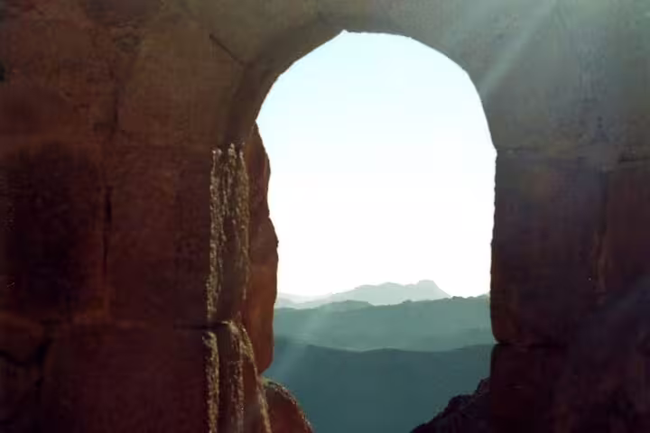 View through stone arch on Mount Sinai trail at dawn, private Sharm el Sheikh Mount Sinai hike day trip