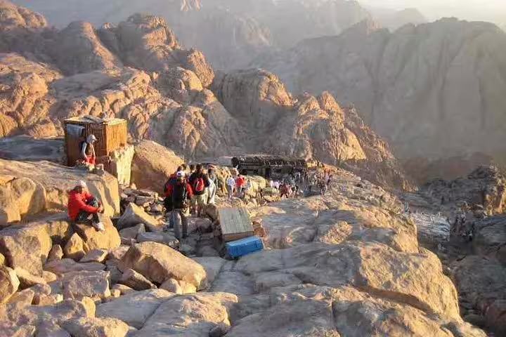 Hikers resting near Mount Sinai summit during Mount Sinai climb and St Catherine Monastery tour from Sharm El Sheikh