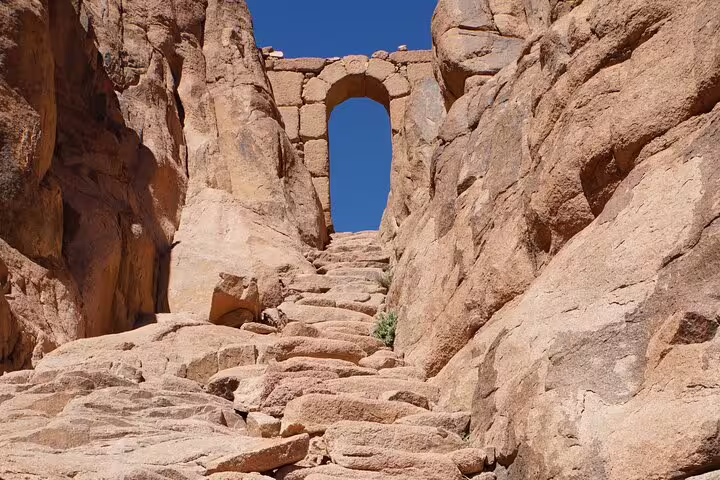Stone steps to ancient arch on Mount Sinai trail, part of Moses Mountain sunrise hike from Taba private tour