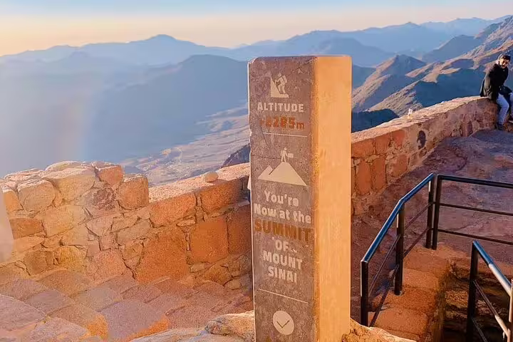 Summit marker at Mount Sinai with mountain views, part of private Mount Sinai climb and St Catherine day tour