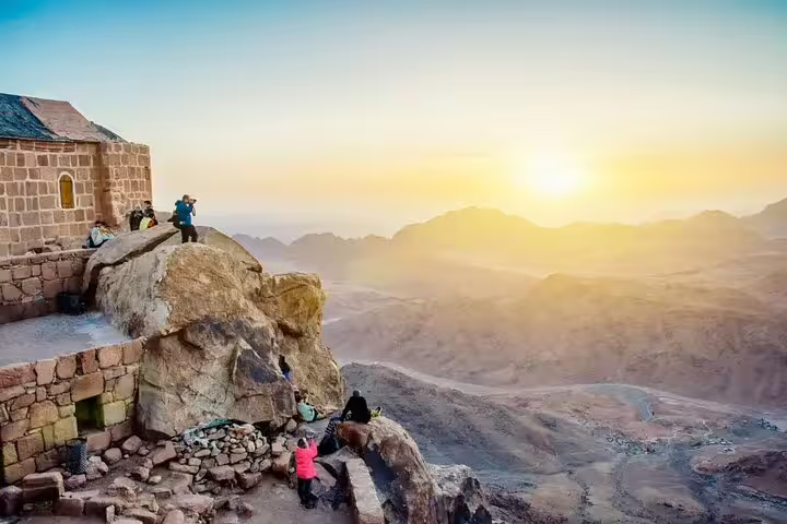 Hikers at Mount Sinai summit at sunrise near St Catherine Monastery on private Sharm el Sheikh day tour