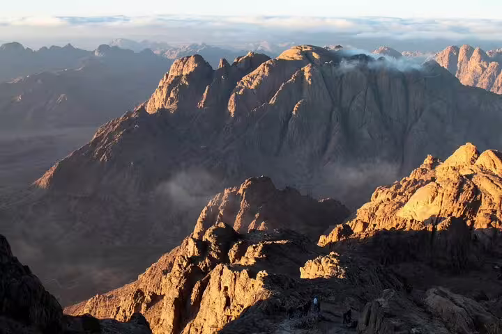 Golden sunrise over rugged Sinai mountains from Mount Sinai hike, part of private Sharm El Sheikh day trip