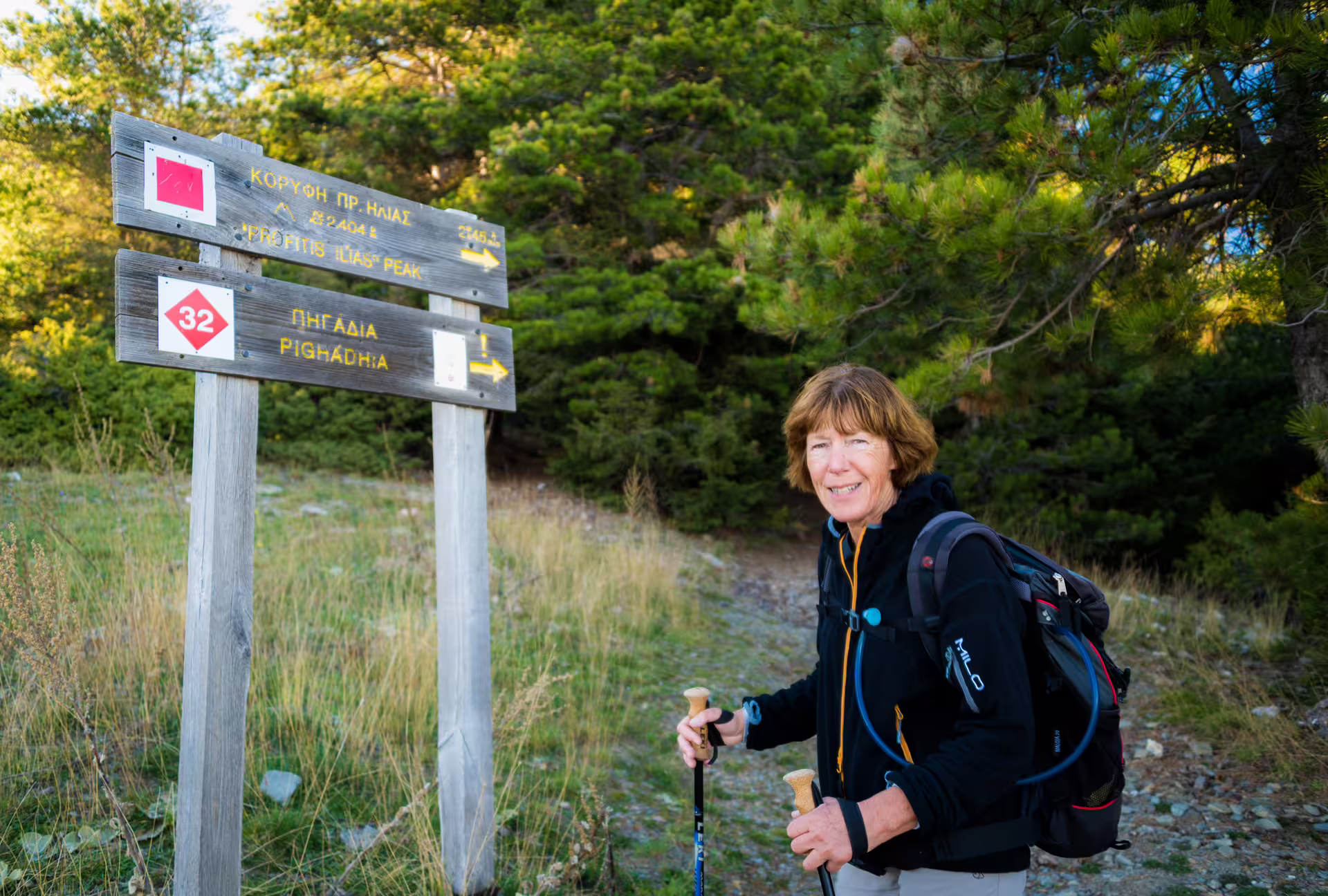 Hiker at trail sign to Profitis Ilias on Mount Taygetos, starting the guided summit trek to 2407m