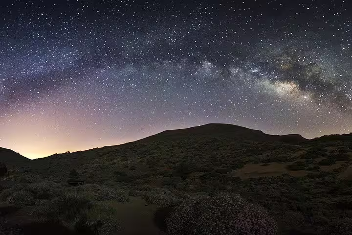 Panoramic view of the Milky Way over Mount Teide's rugged landscape, ideal for astronomy enthusiasts.