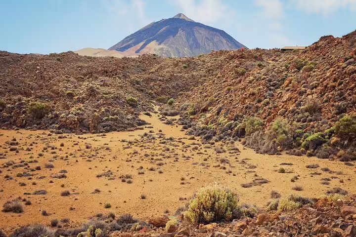 Majestic Mount Teide rises above the rocky terrain and sparse vegetation of Teide National Park, ideal for private tours.