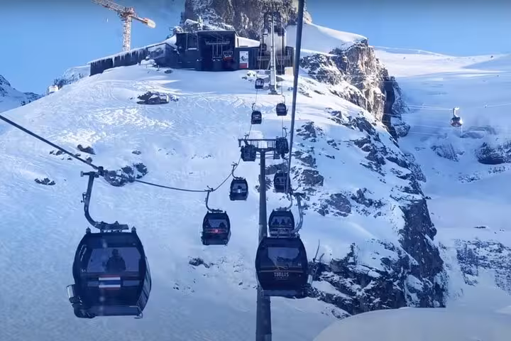 Scenic cable cars ascend snowy peaks at Mount Titlis, offering breathtaking views on a private tour from Luzern.