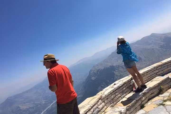Tourists enjoy panoramic views from Mount Tomorr's summit during a guided 4x4 and hiking adventure.