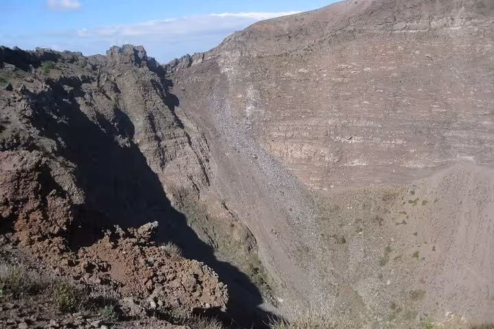 Dramatic crater of Mount Vesuvius under a clear sky, a highlight for visitors on the Pompeii and Vesuvius experience.