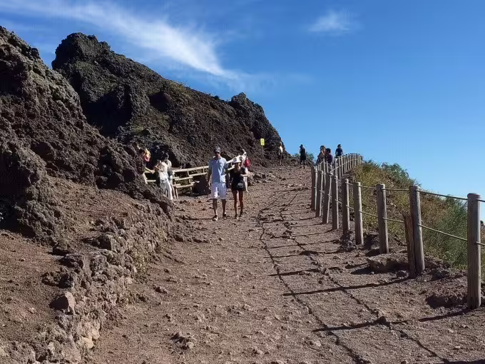 Hikers on the Mount Vesuvius crater trail, popular low-cost Vesuvius tour from Naples with summit views