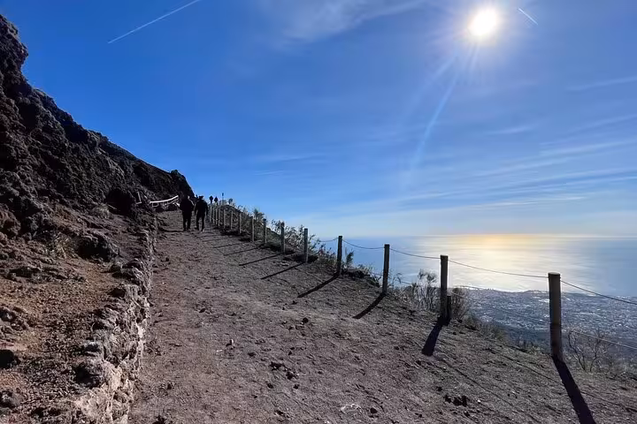 Hike along the scenic path on Mount Vesuvius with stunning sea views, included in our Amalfi Coast day trip.