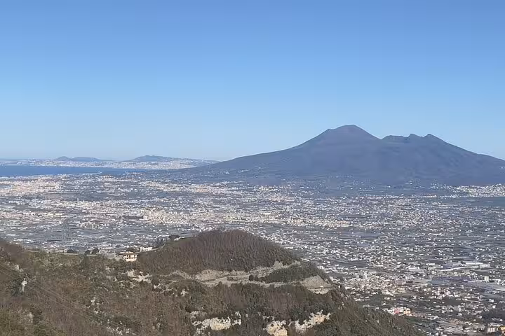 Breathtaking view of Mount Vesuvius with the cityscape of Naples, a key highlight of the Pompeii and Vesuvius small group tour.