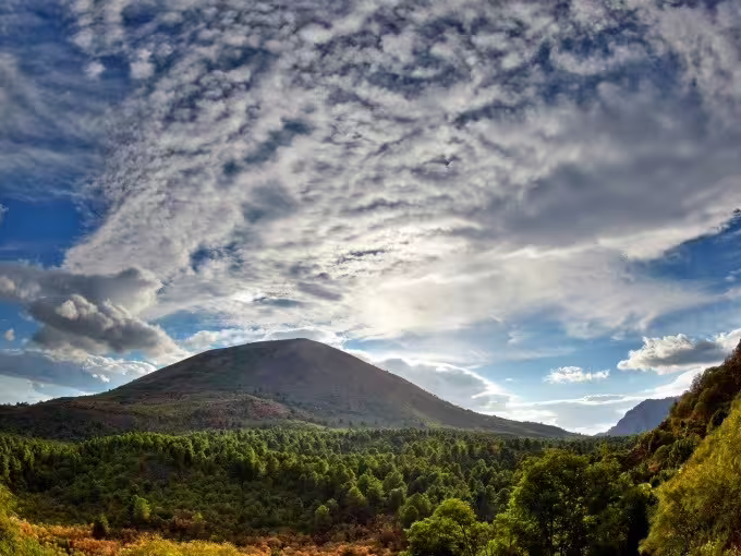 Panoramic Mount Vesuvius landscape under dramatic clouds, nature scenery on budget Vesuvius tour from Naples