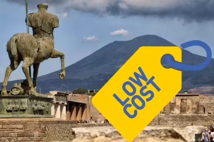 Mount Vesuvius behind Pompeii ruins and statue, highlighting low cost Pompeii & Vesuvius day trip from Naples