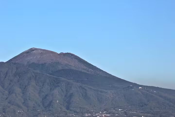 Mount Vesuvius volcano summit under clear sky, scenic stop on Vesuvius group tour from Naples with pickup