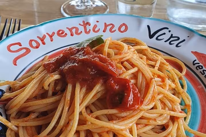 Delicious Italian spaghetti served on a colorful plate at a Mount Vesuvius tour lunch stop.