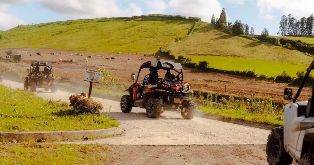 Off-road buggy driving through green Sete Cidades countryside, Azores, on full-day tour with lunch