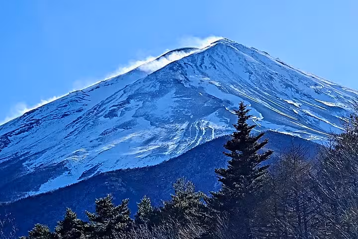Close-up of snow-capped Mt. Fuji peak under clear skies, featured in Yokohama Port to Mt. Fuji guided tour.