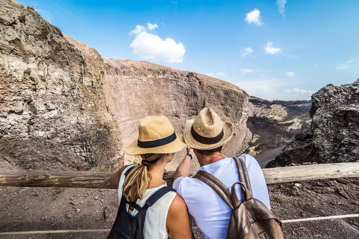 Tourists admire the breathtaking crater view of Mt. Vesuvius on a guided tour from Sorrento, Italy.
