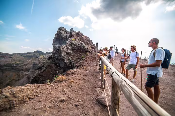 Visitors hike along the rugged path of Mt. Vesuvius, enjoying panoramic views on a guided tour from Sorrento.