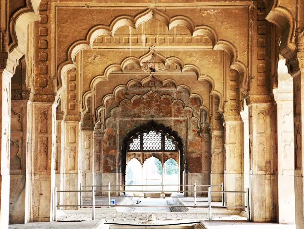 Intricately designed arches in a historic Indian monument, showcasing Mughal architecture on the Golden Triangle with Goa tour.