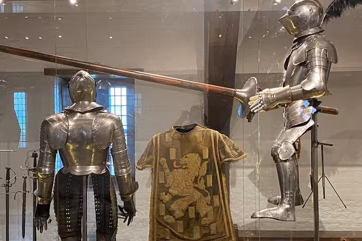 Medieval armor and weapons display inside Muiderslot Castle museum on a private tour from Amsterdam