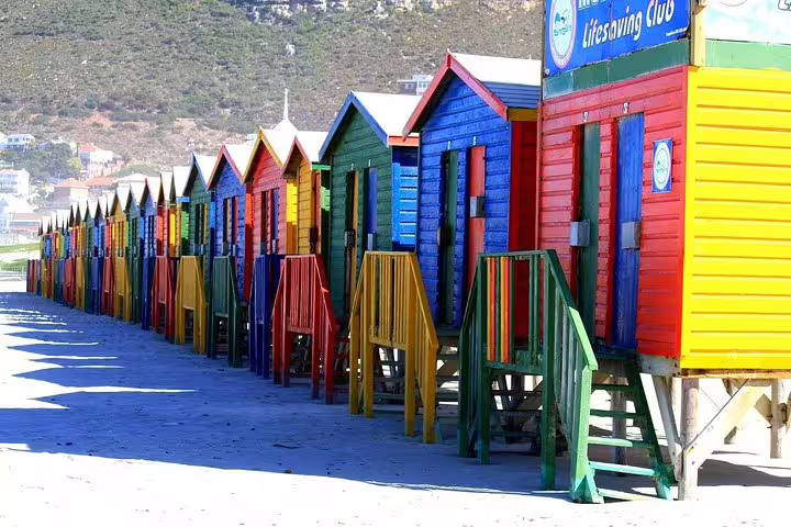 Colorful beach huts at Muizenberg Beach, a vibrant stop on the Private Cape Peninsula Tour from Cape Town.
