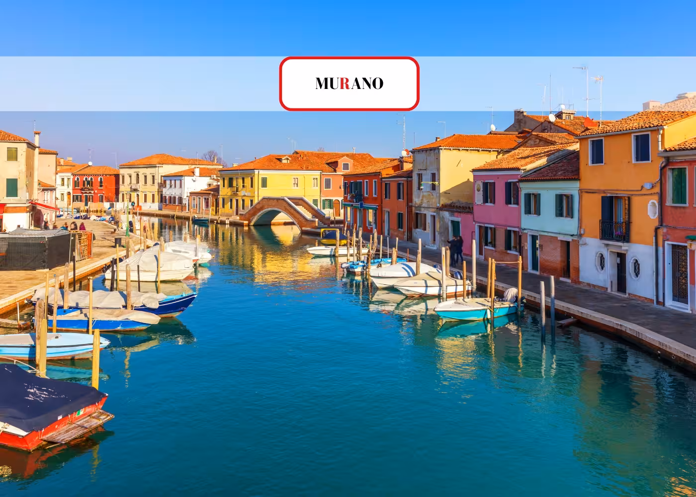 Charming Murano canal with vibrant houses and boats, showcasing the picturesque beauty of this Venetian island.